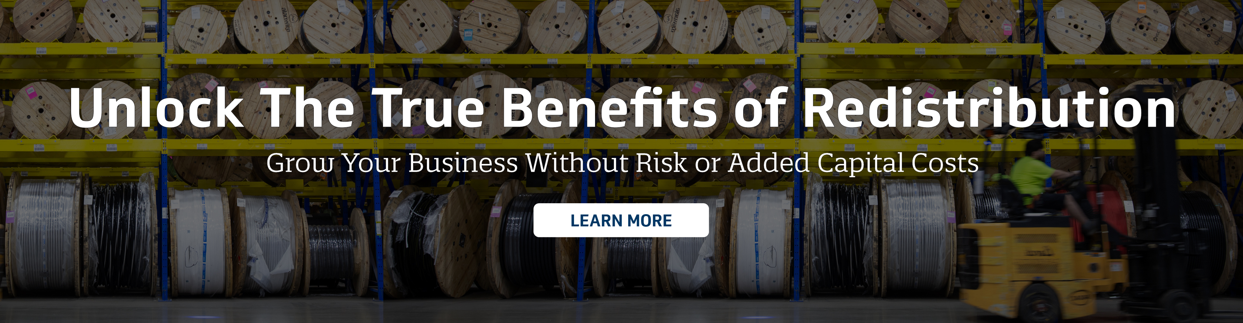 Warehouse image of cable reels and a pallet jack